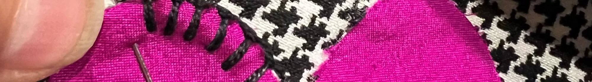 Hand stitching a pink heart applique