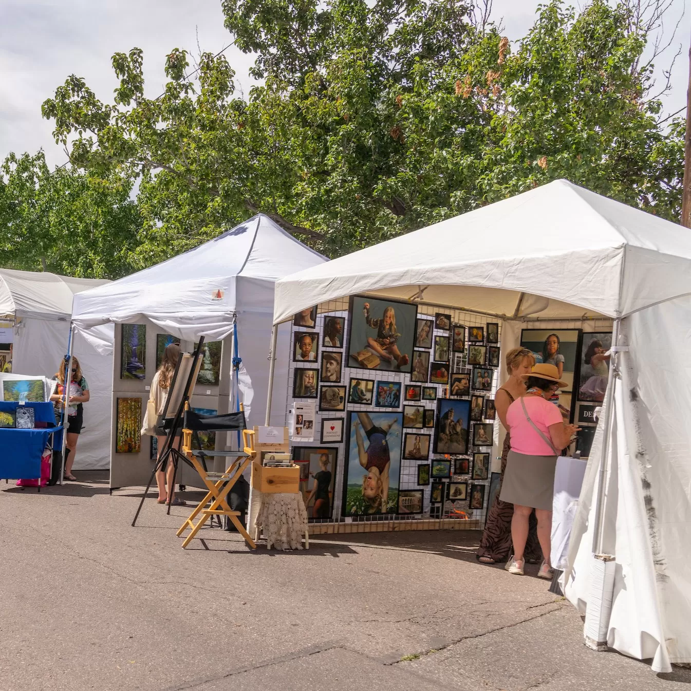 Artists tents with artwork hung inside at Summer Art Market